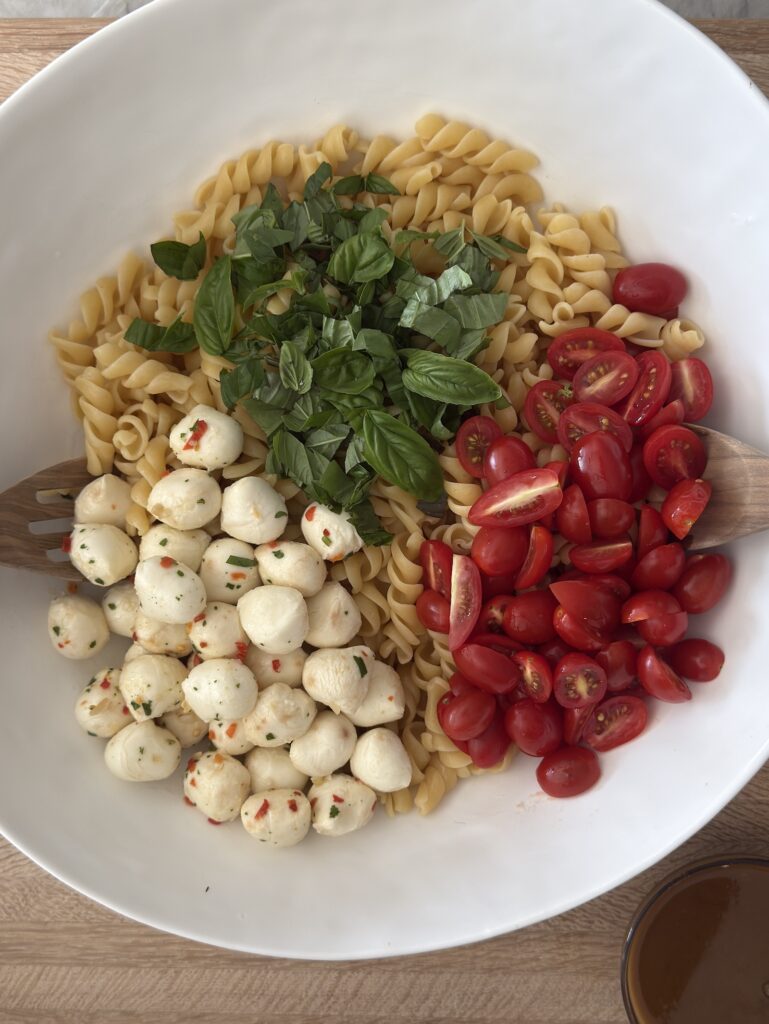Caprese pasta salad with fresh mozzarella, cherry tomatoes, basil, and vinaigrette – easy summer recipe