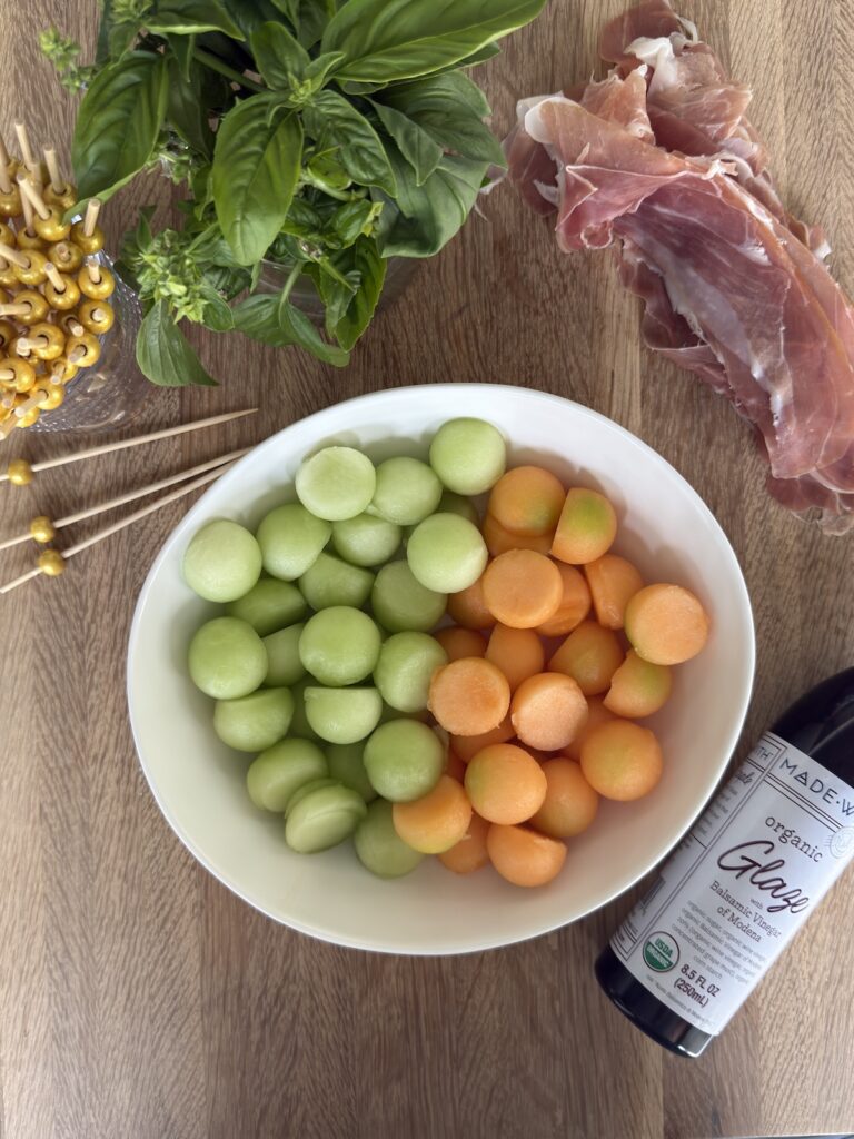 Prosciutto and melon skewers with fresh basil, honeydew, cantaloupe, and balsamic glaze