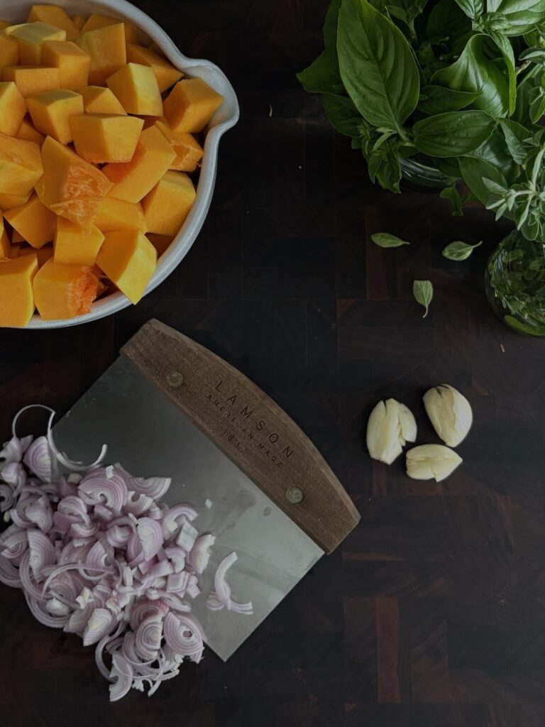 Diced butternut squash and shallots on a cutting board – butternut squash pasta sauce ingredients