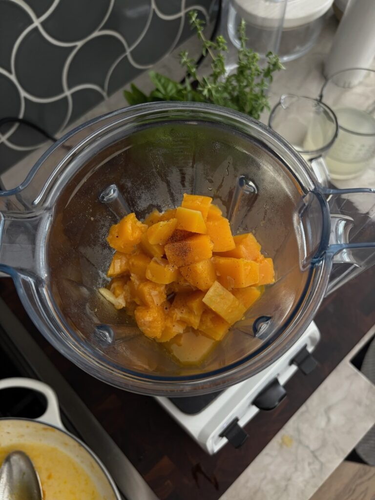 cooked butternut squash in the blender, ready to be pureed.