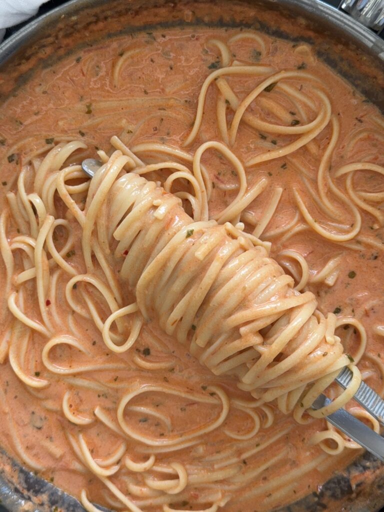 Linguine pasta tossed in spicy tomato cream sauce
