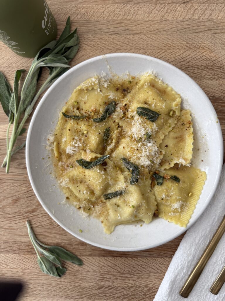 Butternut squash ravioli sprinkled with parmesan and pistachios, finished with crispy sage