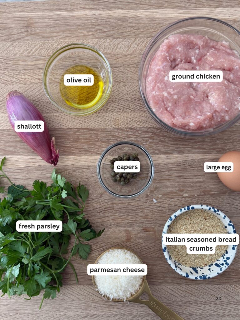 Chicken piccata meatballs ingredients—ground chicken, Italian seasoned breadcrumbs, Parmesan cheese, egg, shallot, parsley, capers, and olive oil—flat lay.