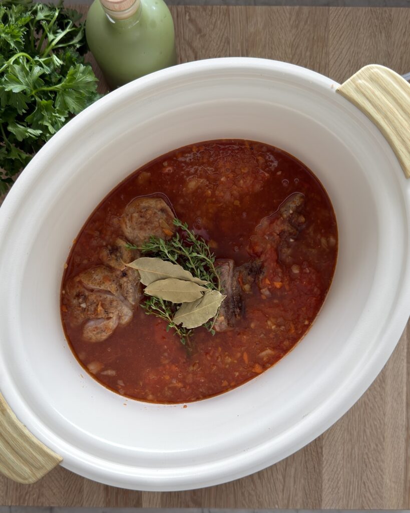 Veal Osso Buco in the slow cooker, ready to cook for 6 hours with fresh herbs.