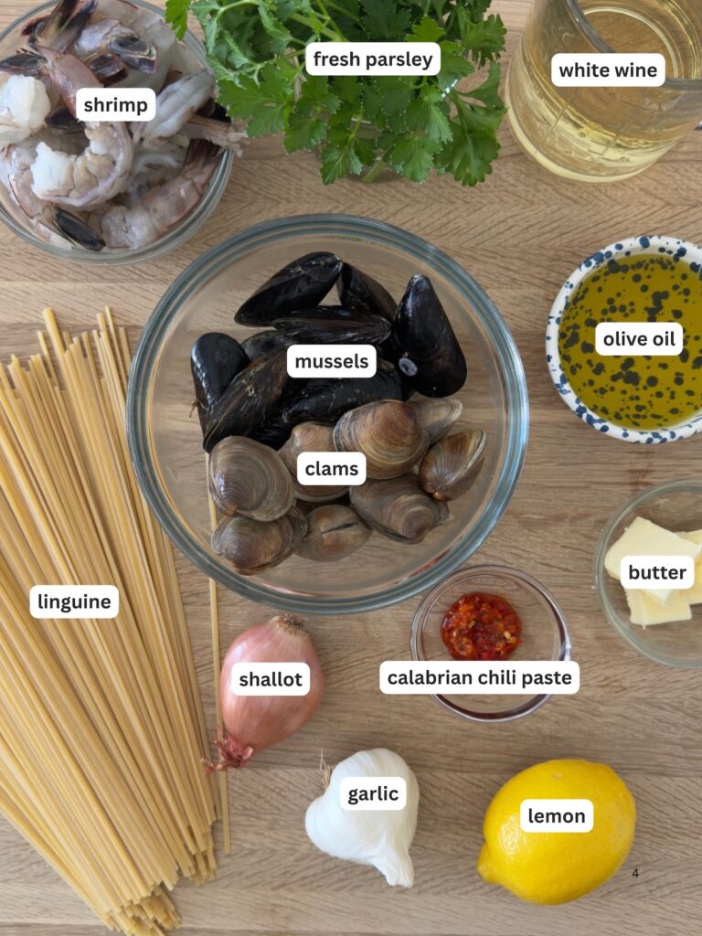 ngredients for seafood linguine including clams, mussels, shrimp, linguine, garlic, shallot, lemon, white wine, and fresh parsley