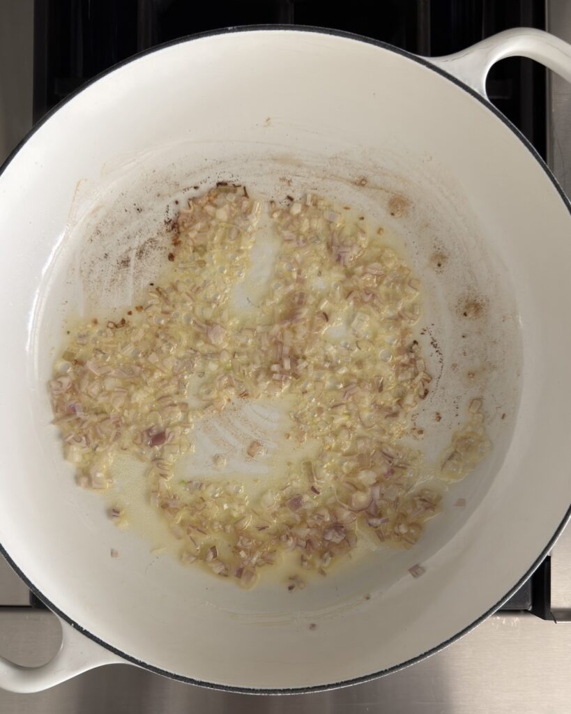 Shallots and garlic sautéing in butter and olive oil to start spring pea risotto.