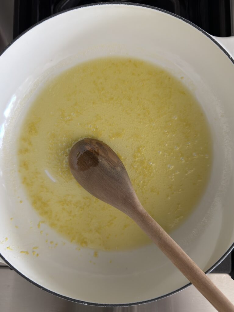 Butter, olive oil and lemon zest melting in a pan to start creamy lemon pasta sauce (spaghetti al limone)