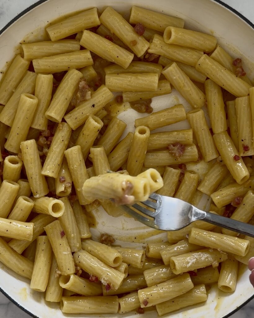 rigatoni carbonara tossed in a creamy egg and Pecorino Romano sauce with pancetta