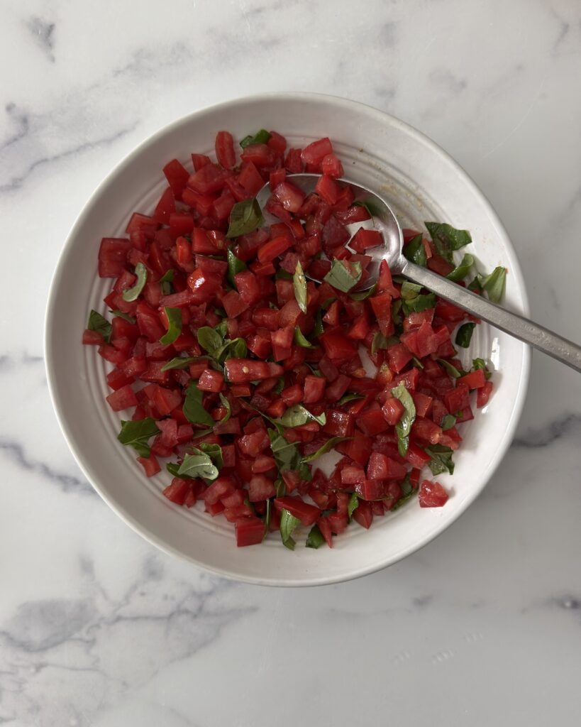 Chopped tomatoes with fresh basil for burrata bruschetta filling