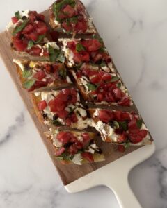 Burrata bruschetta with toasted baguette, creamy burrata, fresh tomatoes, basil, and balsamic glaze