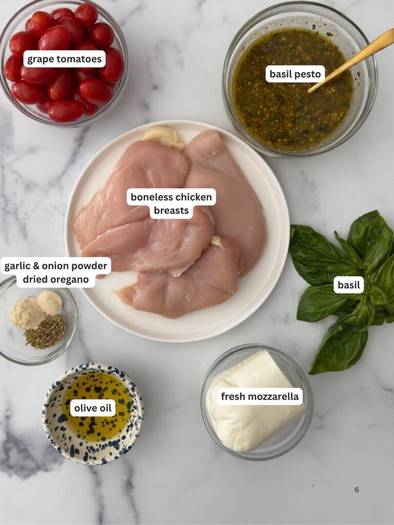 Ingredients for Chicken Margherita including chicken breasts, grape tomatoes, basil pesto, fresh mozzarella, olive oil, and fresh basil.