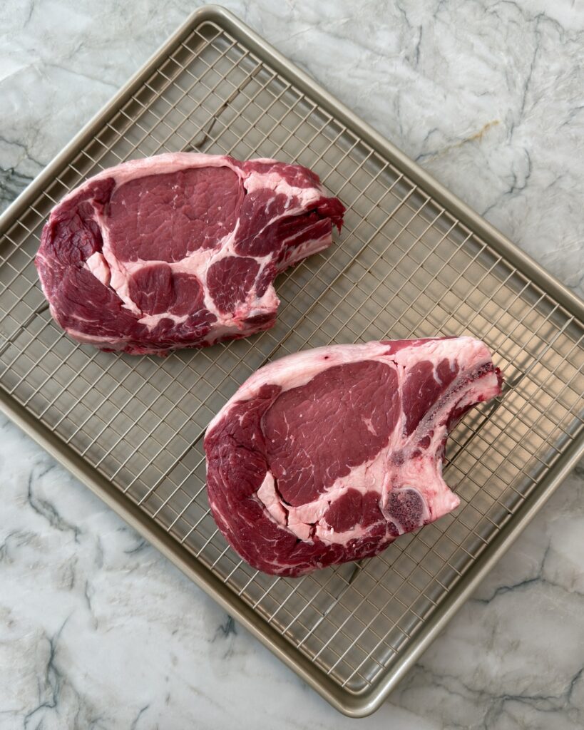 Thick-cut porterhouse steaks before grilling for Italian steak (bistecca alla Fiorentina) recipe.