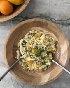 Pastina salad with fennel, orange, red onion, basil, and ricotta salata in a wooden serving bowl