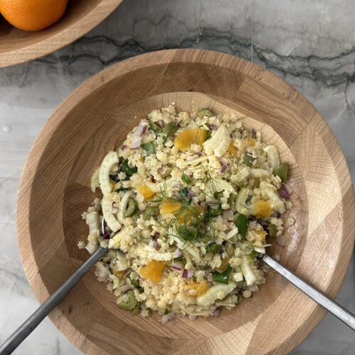 Pastina salad with fennel, orange, red onion, basil, and ricotta salata in a wooden serving bowl
